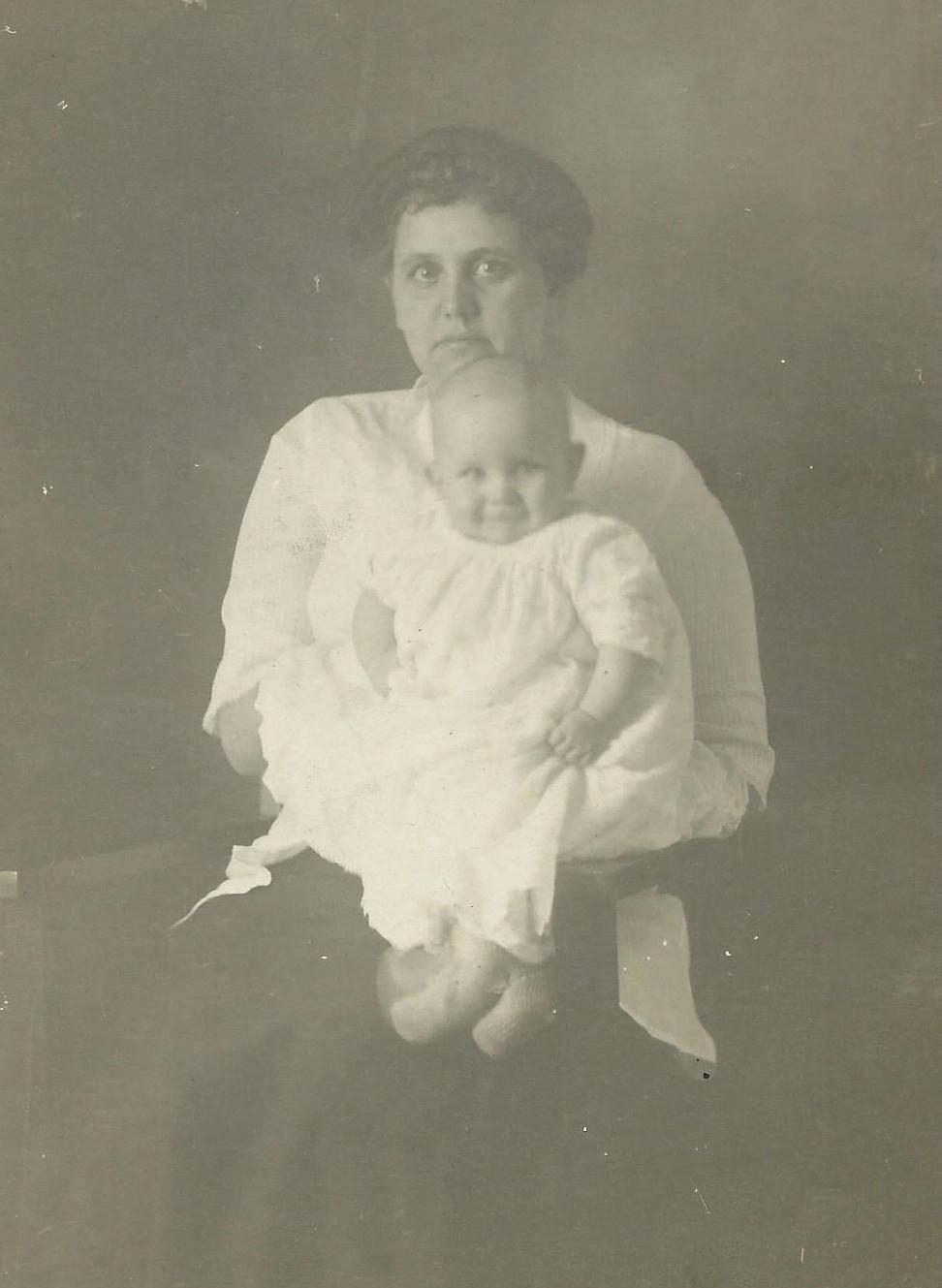 Emma Sarah Merrill McNitt holding a baby, probably her son James.