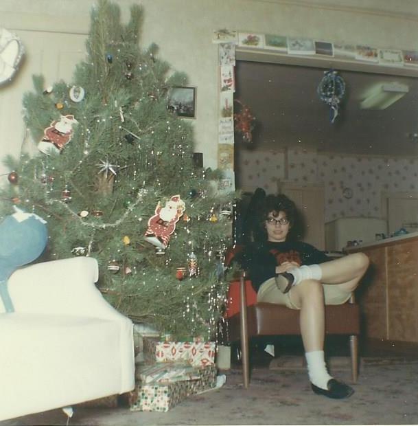 Marilyn Munsell seated next to the Christmas tree