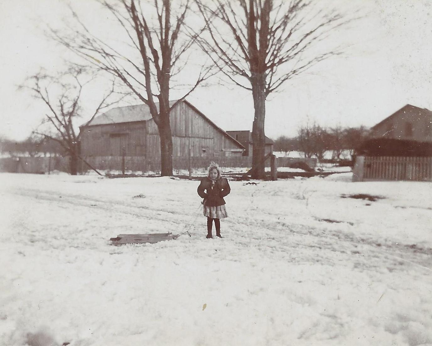 Leta Wilder, granddaughter of Joseph Wilder, with the old mill
building behind her, ca. 1903